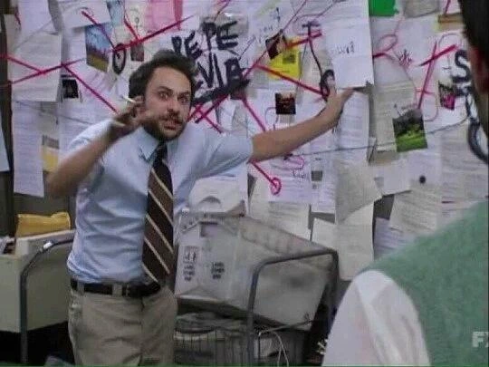 meme image of a man explaining a red-string conspiracy board with a crazed look in his eyes